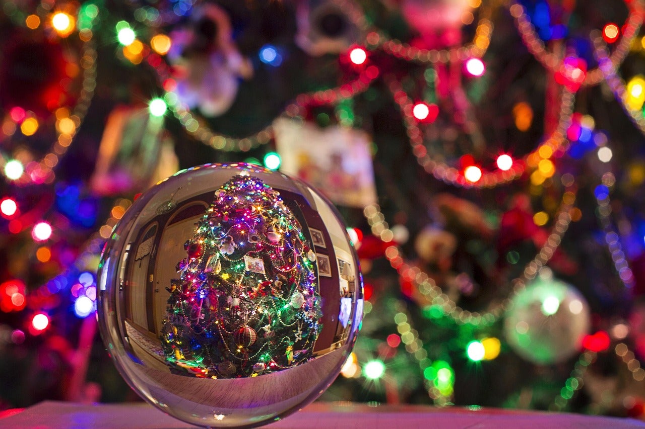 Decorated Christmas tree viewed through a crystal ball.