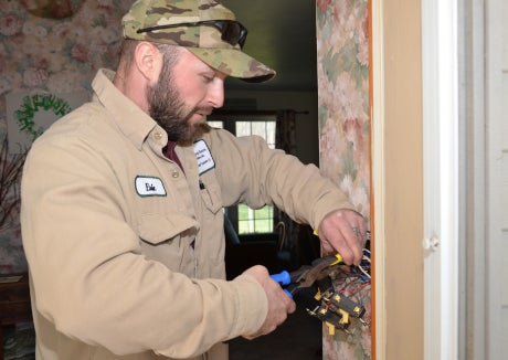 Valley REC electrician using pliers to improve wiring