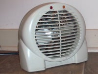 Space heater sitting on floor near wall