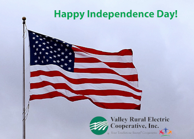 American flag fluttering in a breeze with the greeting Happy Independence Day