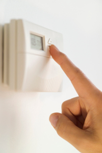 Hand adjusting thermostat setting